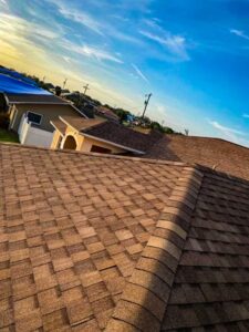 Lightly colored shingles on the peak of a Florida roof